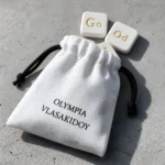 Μαγνήτες Good Vibe πάνω στο υφασμάτινο πουγκί byOlympia σε τσιμεντένια επιφάνεια